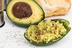Avocado fruit and pit with guacamole